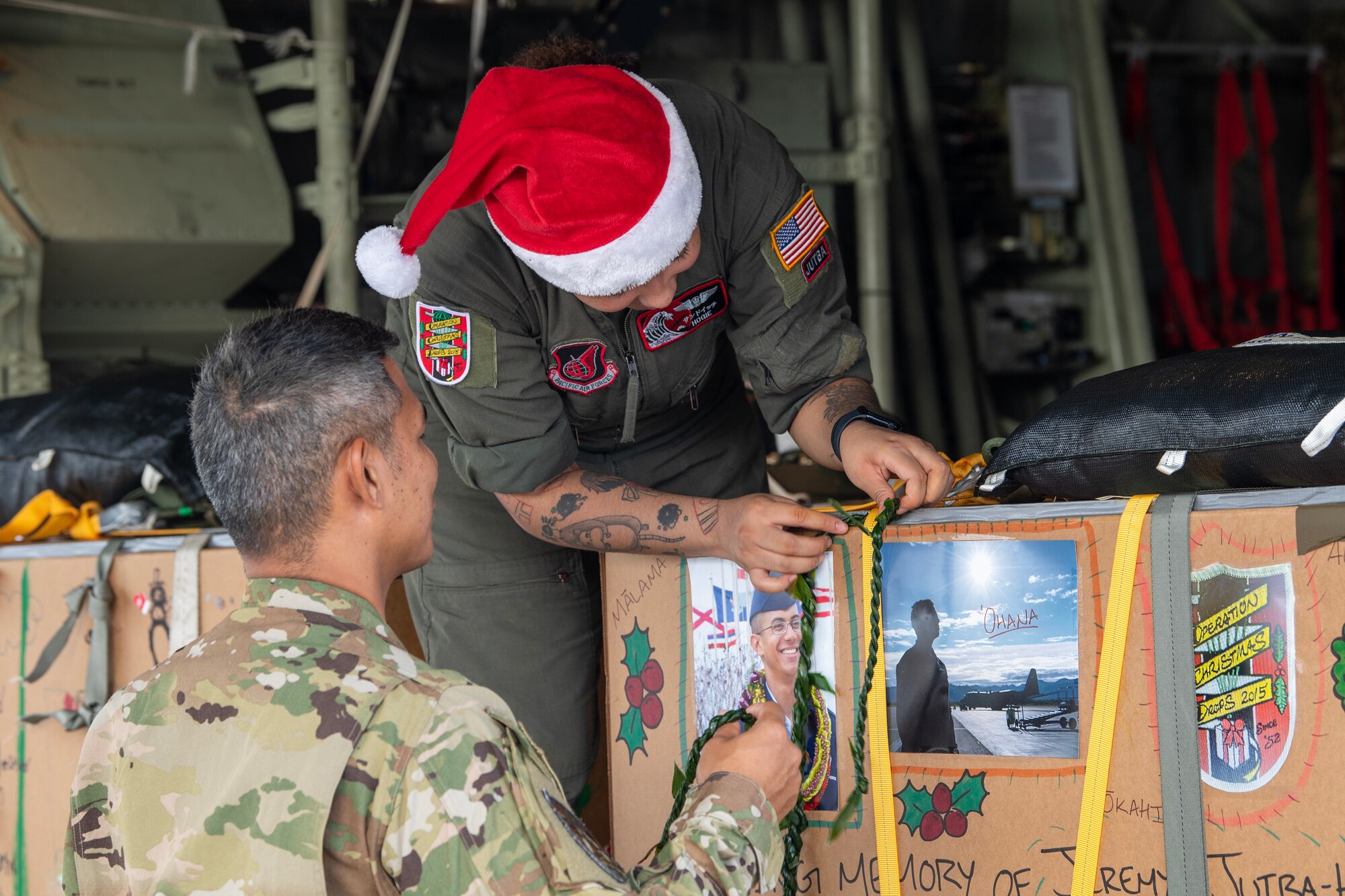 U.S. Air Force Airmen decorate a special humanitarian aid bundle in memory of SrA Jeremy Jutba-Hake