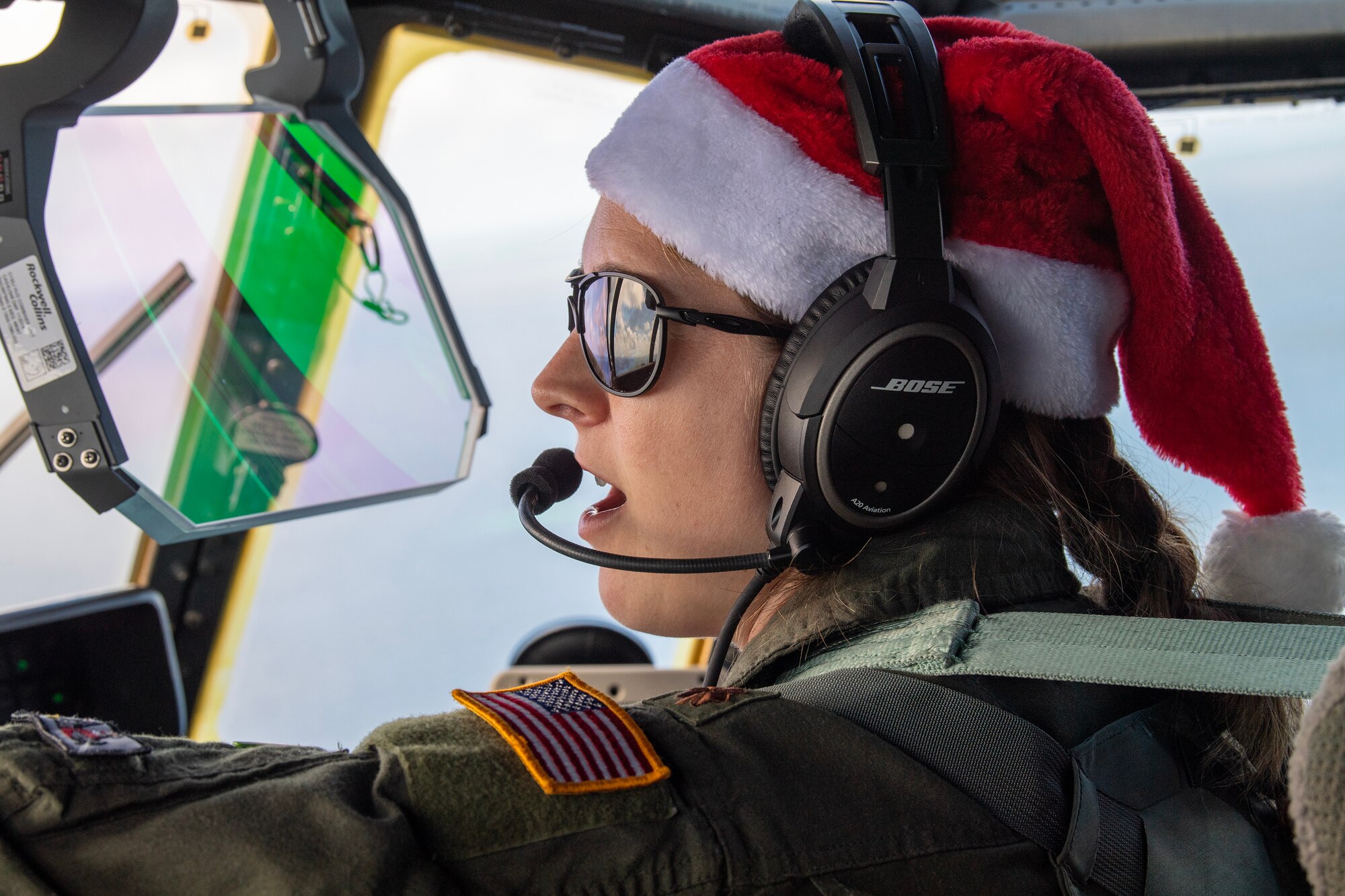 A U.S. Air Force pilots speaks on a headset inside a C-130J Super Hercules