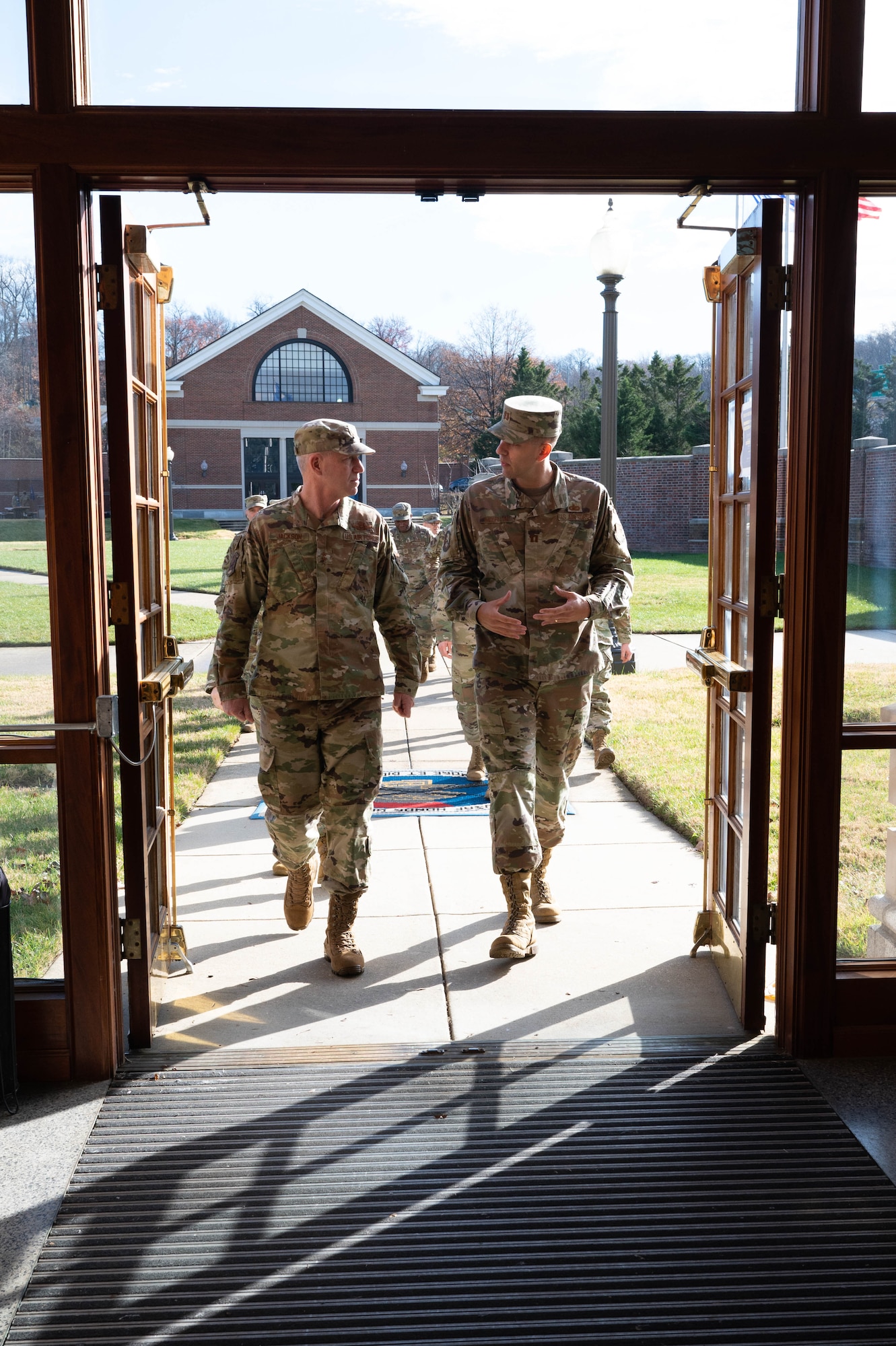 U.S. Air Force Maj. Gen. Joel Jackson, commander of the Air Force District of Washington, and U.S. Air Force Capt. David McLellan, United States Air Force Honor Guard director of operations, discuss the Honor Guard improvement initiatives at Joint Base Anacostia-Bolling, Washington D.C., Dec. 8, 2022. The AFDW command team visited various sections of the wing and base mission partners during a tour to listen, learn, take questions, and recognize the achievements of JBAB Airmen and mission partners. (U.S. Air Force photo by Airman 1st Class Bill Guilliam)