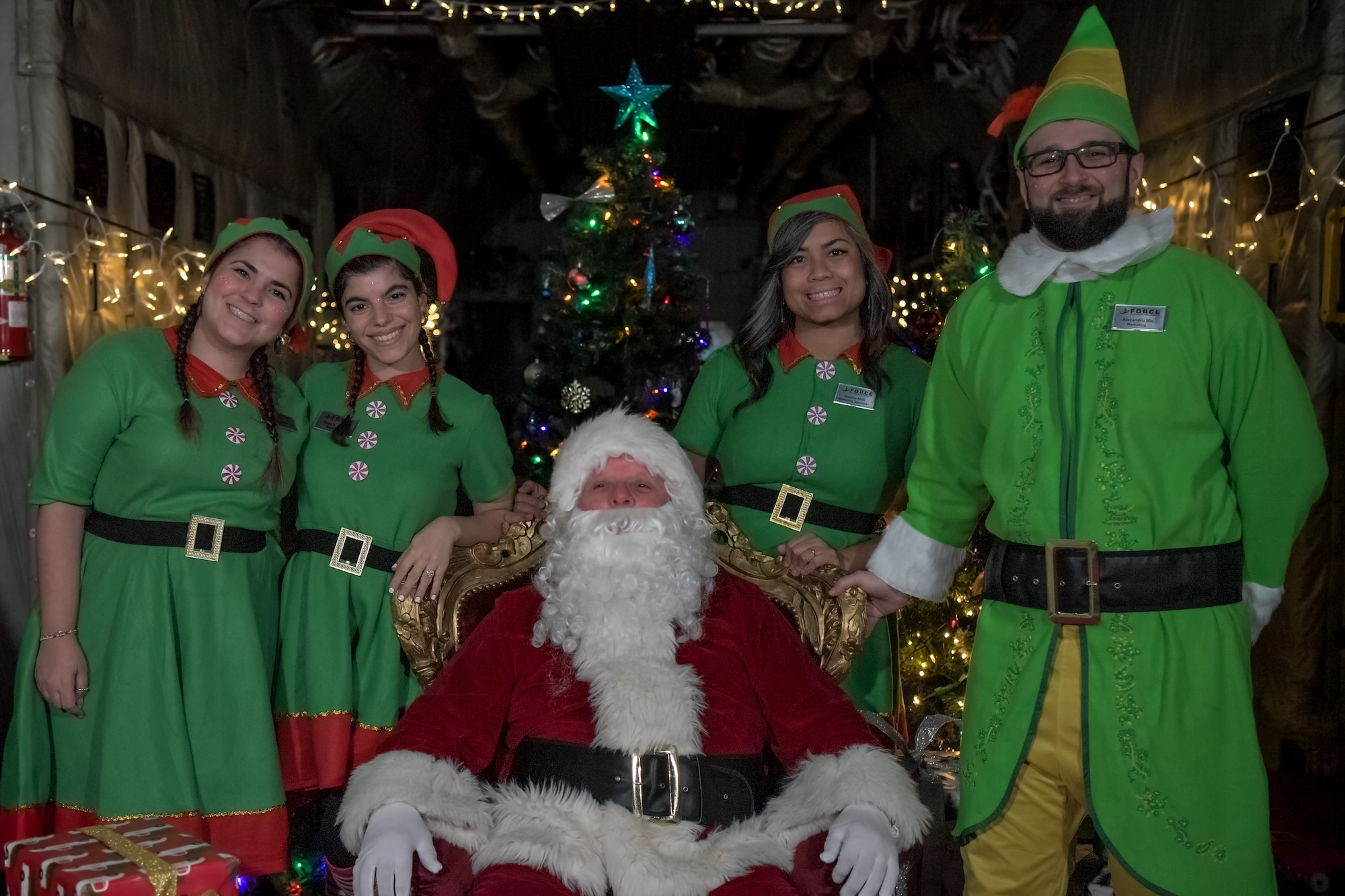 Elves stand with Santa