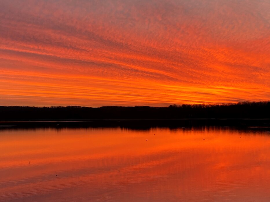 The brilliant colors of sunrises and sunsets are caused by atmospheric particles refracting light through the atmosphere, called scattering. Blue and violet light “scatters” more easily, lending us to primarily see yellow, orange, and red.

Photographer’s Note — “The night this photo was taken I almost did not go to the lake. I got out of work late and knew it was going to get dark in a half hour. However, my dogs love the outdoors and Blue Marsh is their favorite place to go. I figured the lake was just what I needed after a busy day; even if we could only spend a mere 15 minutes there. After arriving at the boat launch, I looked up and witnessed the most amazing sky I had ever seen. I tell this story often and advise people to get outdoors daily!” - Carol Cole