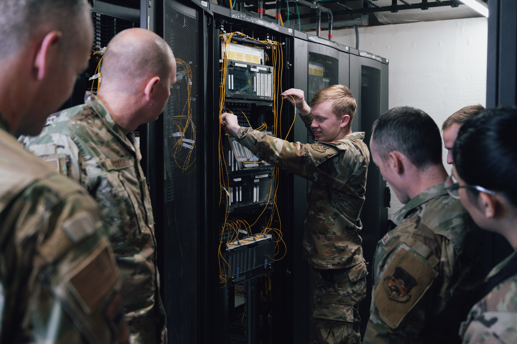 Airman First Class Cameron Phillips, Network Infrastructure Technician, 332d Air Expeditionary
Communications Squadron, instructs leaders from around base on infrastructure transfer
building capabilities as part of the “Red Tail Connection” program at an undisclosed location in
Southwest Asia, Dec. 12, 2022. These immersion visits provide greater insight into the unique
skillsets every Airman brings to the 332d Air Expeditionary Wing Red Tail team. (U.S. Air Force
photo by Tech. Sgt. Richard Mekkri)