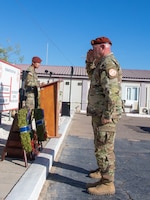 Soldier salutes remembrance wreath