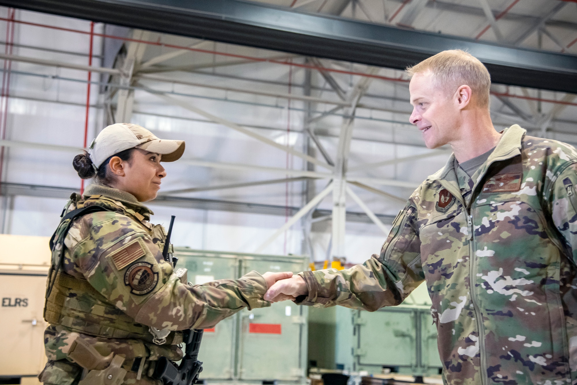 U.S. Air Force Maj. Gen. Derek France, right, Third Air Force commander, presents a coin to U.S. Air Force Senior Airman April Toledo, 420th Air Base Squadron entry controller, at RAF Fairford