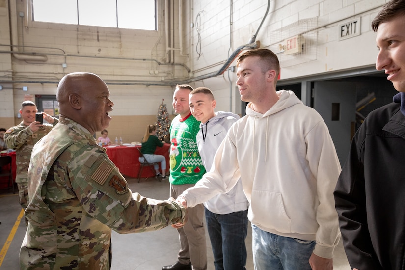 National Guard Senior Enlisted Advisor Tony Whitehead (left) give a coin to Army Spc. Justin Brown of the 223rd Military Police Company, 149th Manuever Enhancement Brigade at Buechel Armory in Louisville, Ky. on Dec. 4, 2022. Whitehead visited Kentucky to recognize Soldiers for their work throughout the year. (U.S. Army photo by Staff Sgt. Andrew Dickson)