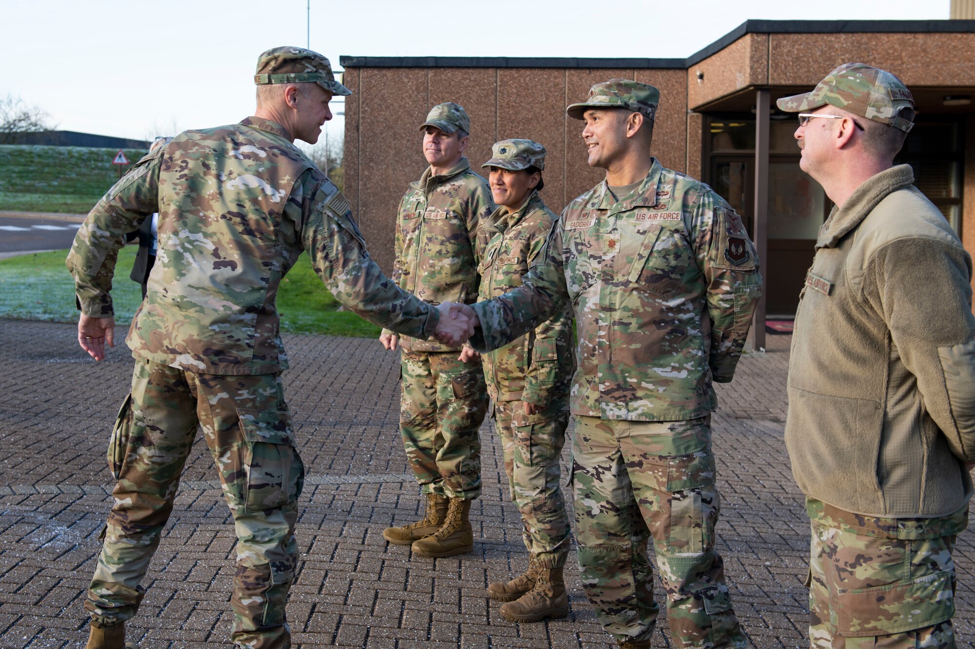 U.S. Air Force Maj. Jethro Sadorra, right, 422nd Civil Engineer Squadron commander, greets U.S. Air Force Maj. Gen. Derek France, left, Third Air Force commander at RAF Croughton