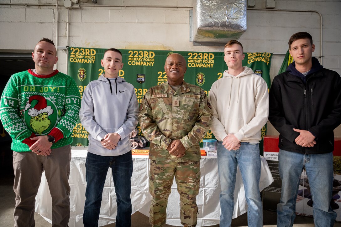 From left to right, Army Sgt 1st Class Frederick Ulshafer, Spc. Tyler Weilage, National Guard Senior Enlisted Advisor Tony Whitehead, Spc. Justin Brown, and Pfc. Bradley Minor pose for a photo at Buechel Armory in Louisville, Ky. on Dec. 4, 2022. Ulshafer, Weilage, Brown, and Minor, from 223rd Military Police Company, 149th MEB, were given a coin by Whitehead for their hard work throughout the year. (U.S. Army photo by Staff Sgt. Andrew Dickson)