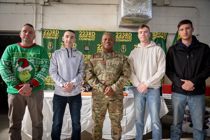 From left to right, Army Sgt 1st Class Frederick Ulshafer, Spc. Tyler Weilage, National Guard Senior Enlisted Advisor Tony Whitehead, Spc. Justin Brown, and Pfc. Bradley Minor pose for a photo at Buechel Armory in Louisville, Ky. on Dec. 4, 2022. Ulshafer, Weilage, Brown, and Minor, from 223rd Military Police Company, 149th MEB, were given a coin by Whitehead for their hard work throughout the year. (U.S. Army photo by Staff Sgt. Andrew Dickson)