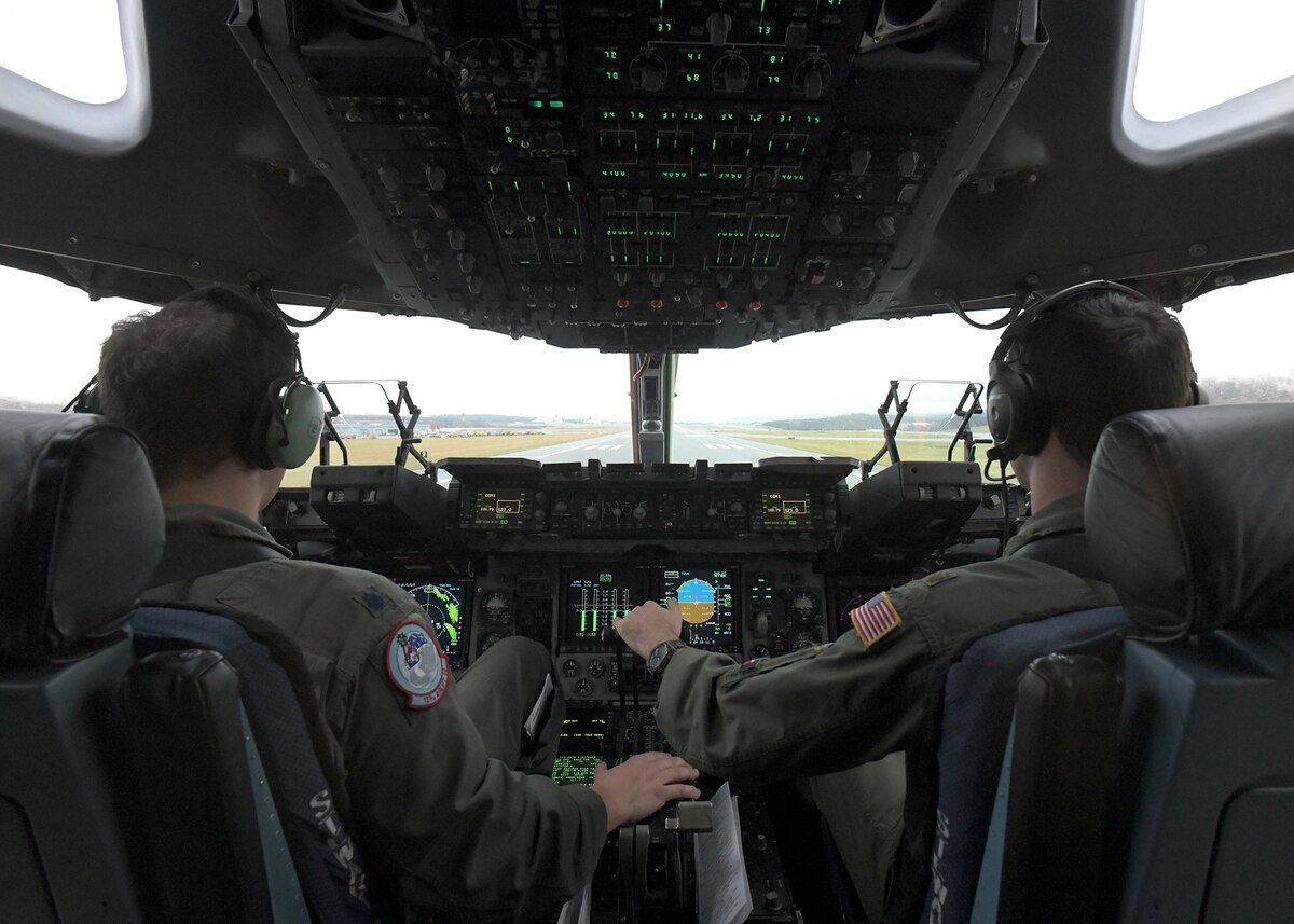 U.S. Air Force Lt. Col. Kristopher Johnson, commander 137th Airlift Squadron, and U.S Air Force Maj. Daniel Dunbar, a pilot assigned to the 105th Airlift Wing, prepare for takeoff aboard a C-17 Globemaster at Stewart Air National Guard Base Newburgh, New York, Dec. 7, 2022.