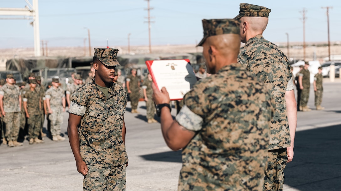 U.S. Marine Corps Lance Cpl. Michael A. Presley, a cannoneer with 3rd Battalion, 11th Marine Regiment, 1st Marine Division, stands at the position of attention during a battalion formation at Marine Corps Air Ground Combat Center, Twentynine Palms, California, May 23, 2022. Presley was awarded the Navy and Marine Corps Achievement Medal for saving the occupants of a flipped over vehicle near Palm Springs, California, in October 2021. Presley is a native of Buncombe County, North Carolina. (U.S. Marine Corps photo by Cpl. Shane T. Beaubien)