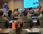 Air Force aviators receive a briefing on Air Force Recruiting Service Detachment 1