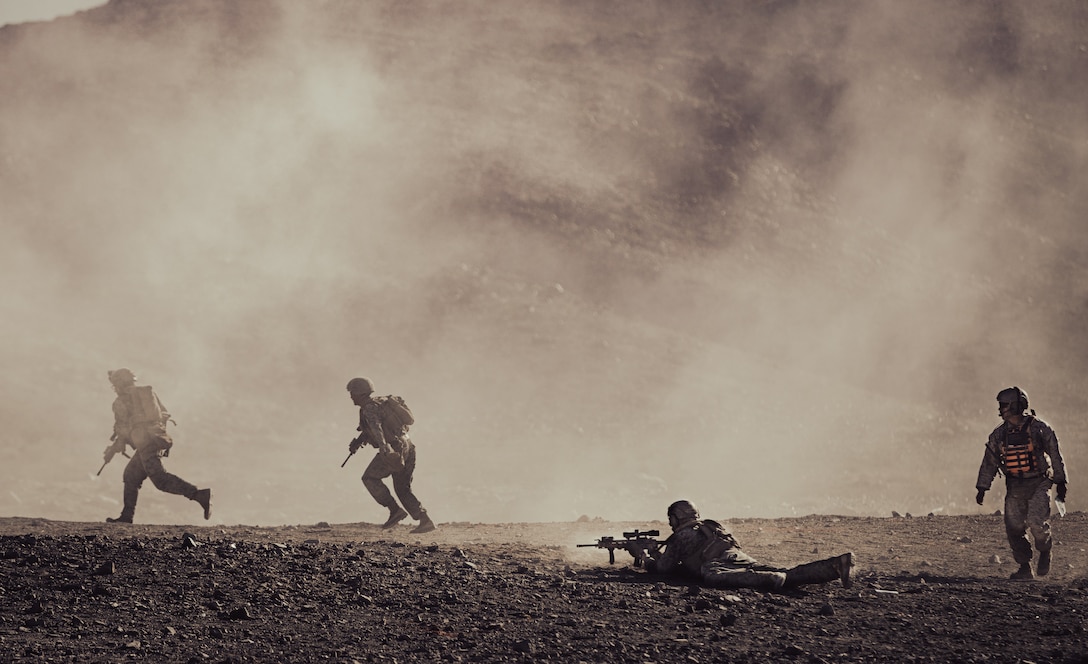 U.S. Marines with 2nd Battalion, 1st Marine Regiment, 1st Marine Division, maneuver towards a trench in a live-fire training event during Service Level Training Exercise 1-23 at Marine Corps Air Ground Combat Center (MCAGCC), Twentynine Palms, Oct. 24, 2022. Marines participating in Mountain Exercise at Marine Corps Mountain Warfare Training Center, Bridgeport, transit to MCAGCC to execute the live-fire portion of their training iteration. (U.S. Marine Corps photo by Cpl. Shane T. Beaubien)