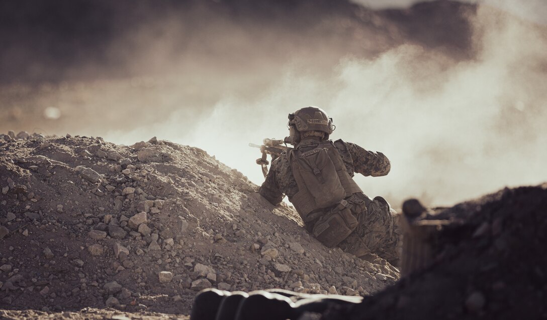 U.S. Marine Corps Lance Cpl. Shane Burnett, a riflemen with 2nd Battalion, 1st Marine Regiment, 1st Marine Division, engages simulated targets in a live-fire training event during Service Level Training Exercise 1-23 at Marine Corps Air Ground Combat Center (MCAGCC), Twentynine Palms, Oct. 24, 2022. Marines participating in Mountain Exercise at Marine Corps Mountain Warfare Training Center, Bridgeport, transit to MCAGCC to execute the live-fire portion of their training iteration. (U.S. Marine Corps photo by Cpl. Shane T. Beaubien)