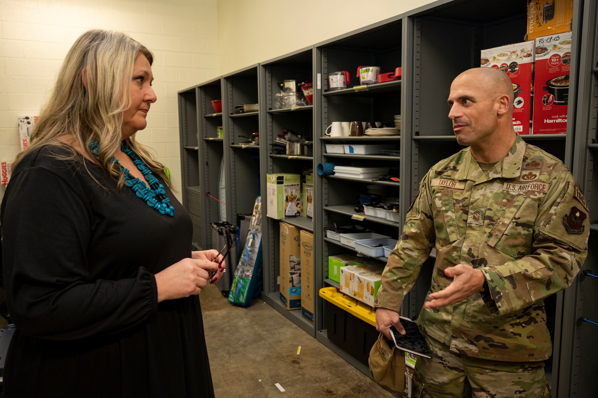 U.S. Air Force Chief Master Sgt. Ryan Taylor, Air Education and Training Command first sergeant, right, speaks with Susan Hunter, 49th Force Support Squadron work-life specialist, about the importance of the Military and Family Readiness Center at Holloman Air Force Base, New Mexico, Dec. 7, 2022. Taylor visited places that help Airmen and their families including the Refuel Cafe and Child Development Center. (U.S. Air Force photo by Airman 1st Class Nicholas Paczkowski)