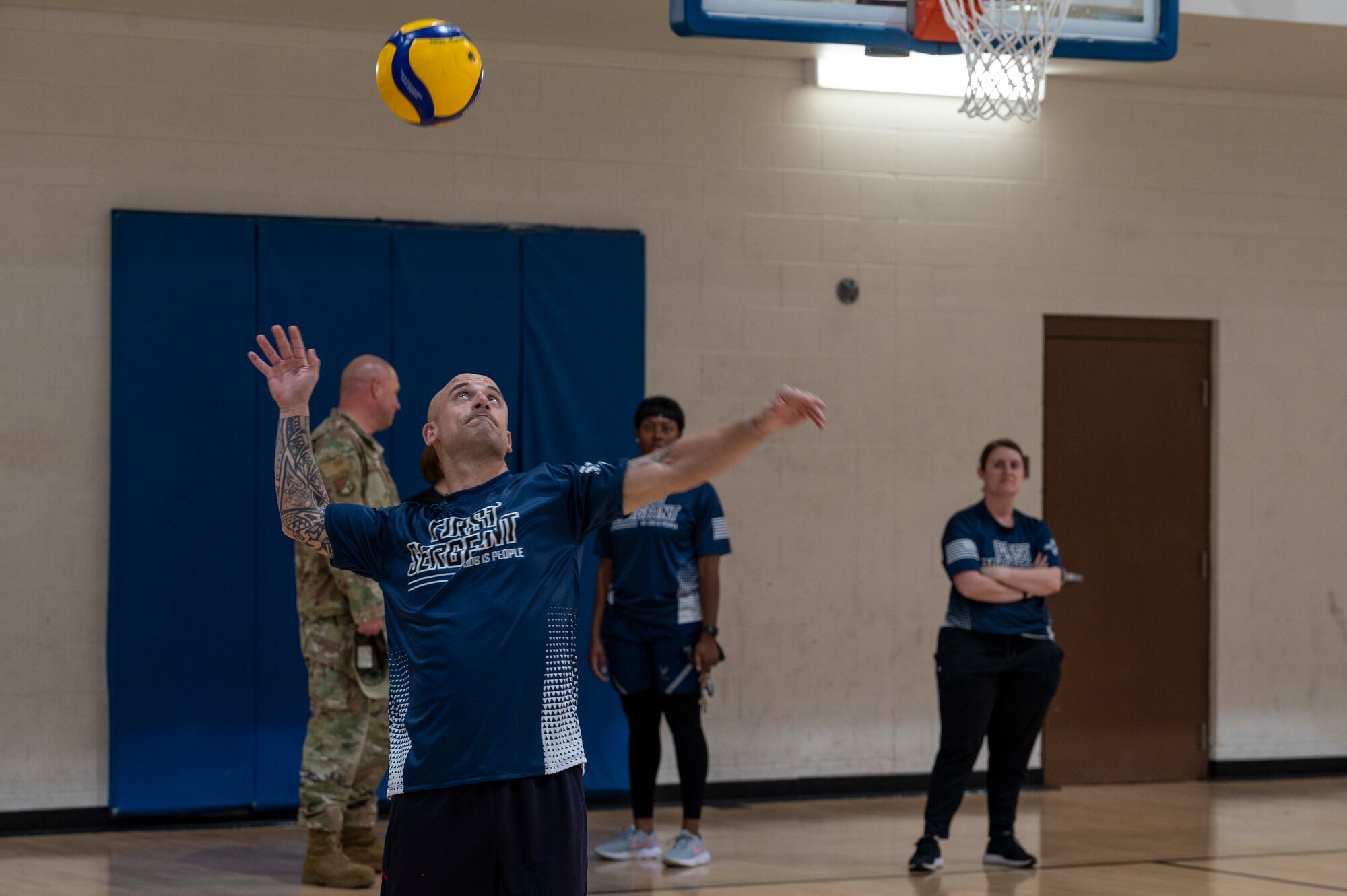 U.S. Air Force Chief Master Sgt. Ryan Taylor, Air Education and Training Command first sergeant, serves a volleyball during a game against Airman Leadership School students at Holloman Air Force Base, New Mexico, Dec. 9, 2022. Taylor is responsible for the management of all of the first sergeants within AETC. (U.S. Air Force photo by Airman 1st Class Nicholas Paczkowski)