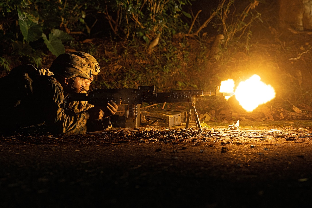 U.S. Marine Corps Lance Cpl. Luis DelacruzRios, a motor transport operator, and Cpl. Samuel Llamas, a combat engineer, both with 3rd Landing Support Battalion, Combat Logistics Regiment 3, 3rd Marine Logistics Group, execute a simulated convoy ambush with an M240B medium machine gun during exercise Winter Workhorse, at Central Training Area, Camp Hansen, Okinawa, Japan, Dec. 6, 2022. Winter Workhorse is an annual exercise for CLR-3 to train to carry out mission essential tasks in forward-deployed, austere environments.