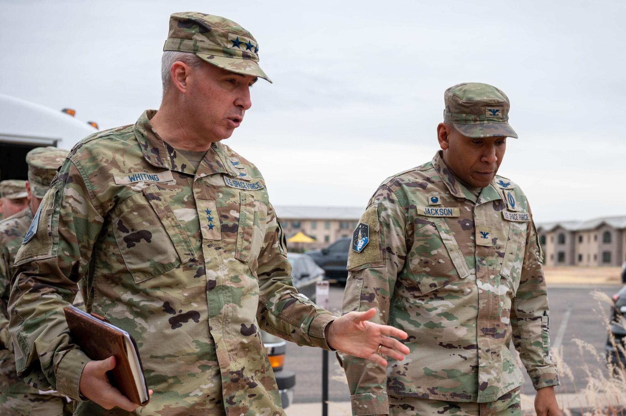 Lt. Gen. Stephen Whiting, commander of Space Operations Command, left, alongside Col. Marcus Jackson, commander of Space Base Delta 2, right, walk into the installation fellowship hall to meet with Airman and Guardians for a luncheon as a part of Lt. Gen. Whiting’s visit at Buckley Space Force Base, Colo., 12 Dec, 2022.