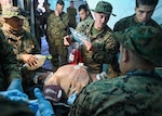 2nd Medical Battalion medical personnel prepare to operate on a surgical suit during a simulated mass casualty event as part of Exercise Carolina Response.