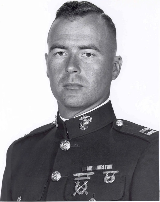 A man in uniform poses for a photo.