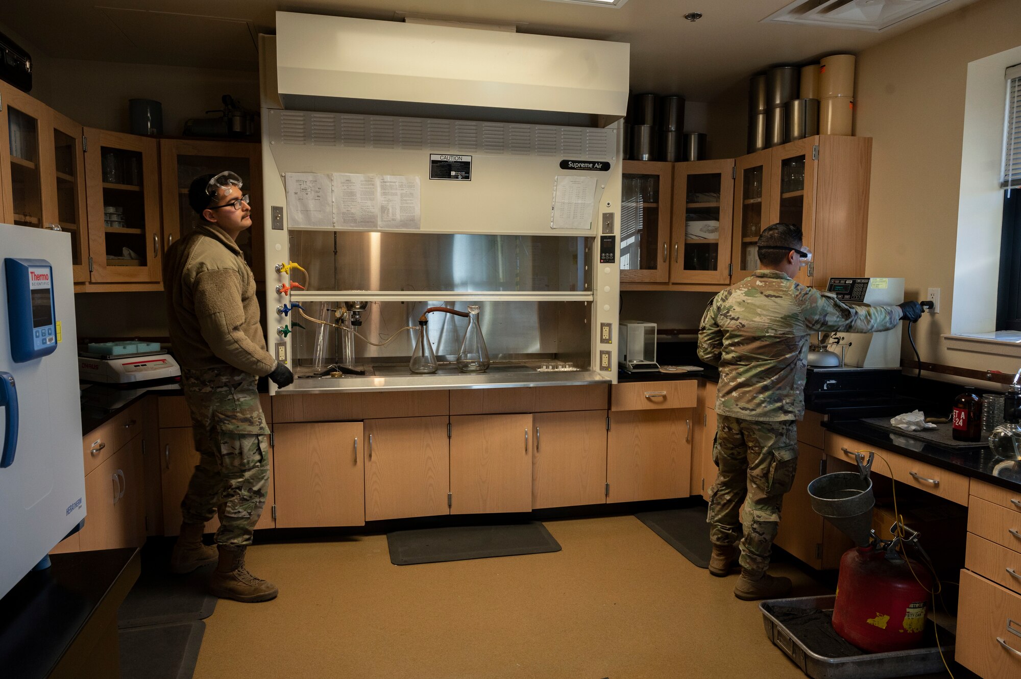 U.S. Air Force Senior Airman Jose Salazar, 49th Logistics Readiness Squadron fuels laboratory technician, left, and U.S. Air Force Staff Sgt. Austin Taitingfong, 49th Logistic Readiness Squadron fuels laboratory noncommissioned officer in charge, conclude their fuel sample testing and secure their work environment at Holloman Air Force Base, New Mexico, Dec. 12, 2022. Personnel from the 49th LRS fuels laboratory implement sampling, testing, accounting and storage of fuel products here on base. (U.S. Air Force photo by Airman 1st Class Isaiah Pedrazzini)