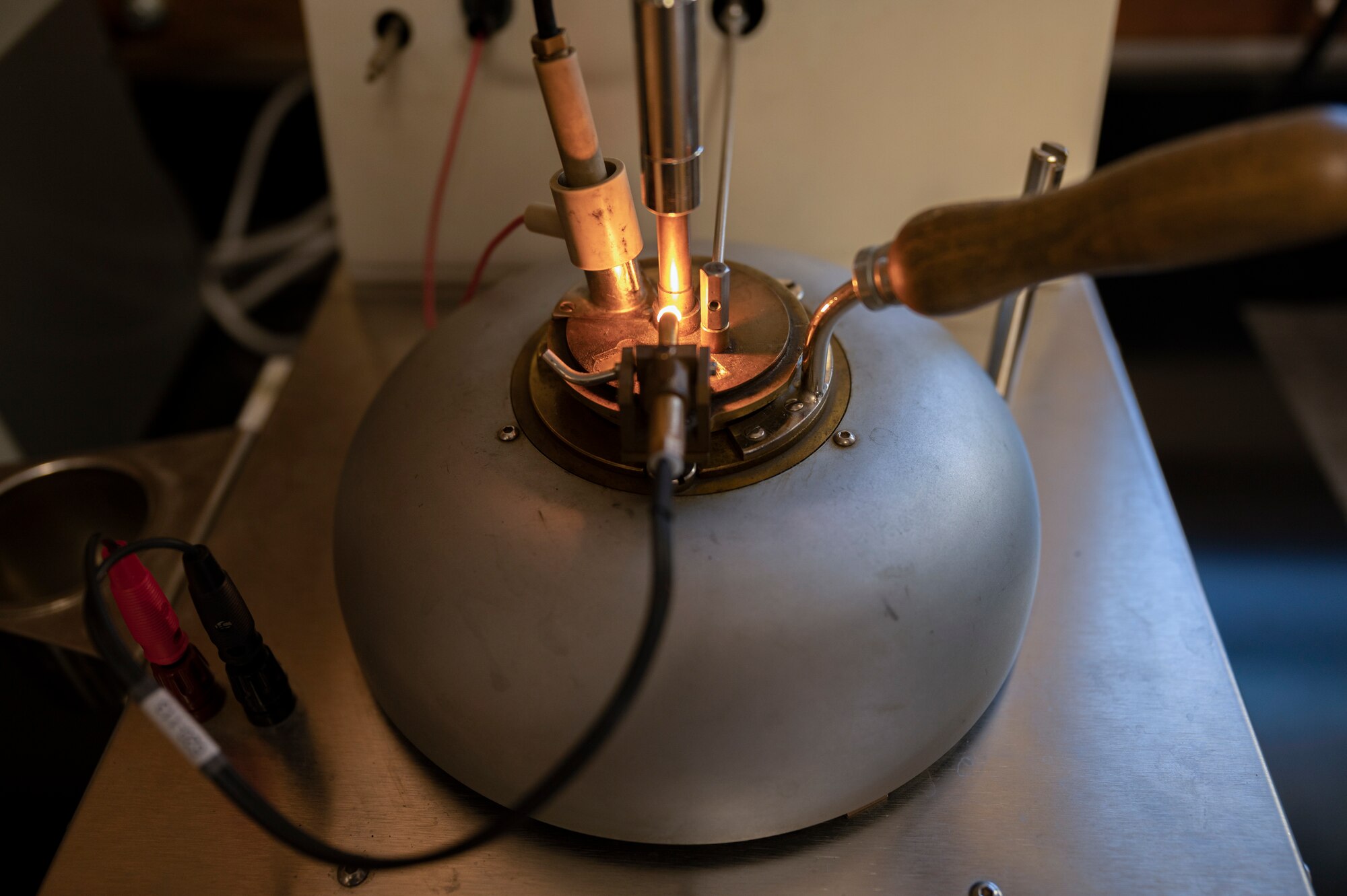 An Airman from the 49th Logistic readiness Squadron fuels laboratory uses a Pensky-Martens flash point tester to test the ignition point of a fuel sample at Holloman Air Force Base, New Mexico, Dec. 12, 2022. The flash point ensures that all fuel provided by the 49th LRS fuels laboratory is ignited at the right level so that all units receive safe and efficient fuel reserves. (U.S. Air Force photo by Airman 1st Class Isaiah Pedrazzini)