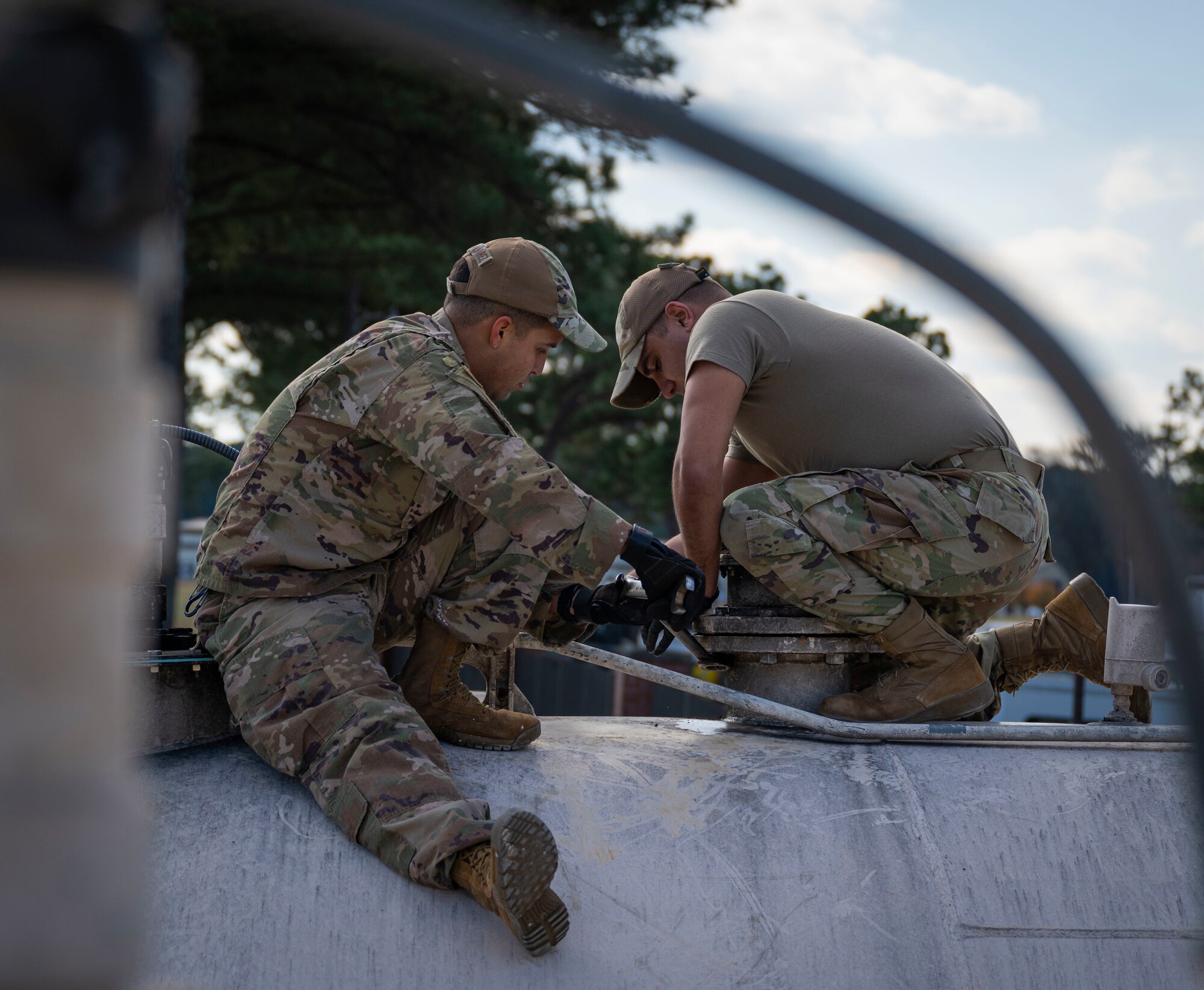 Senior Airman Justin Bellivan, left, and Staff Sgt. Christian Munoz-Alvarez, 4th Civil Engineer Squadron liquid fuels maintenance technicians, replace an emergency vent on a fuel tank at Seymour Johnson Air Force Base, North Carolina, Dec. 13, 2022. The fuel tanks can hold diesel fuel or motor vehicle unleaded regular fuel.