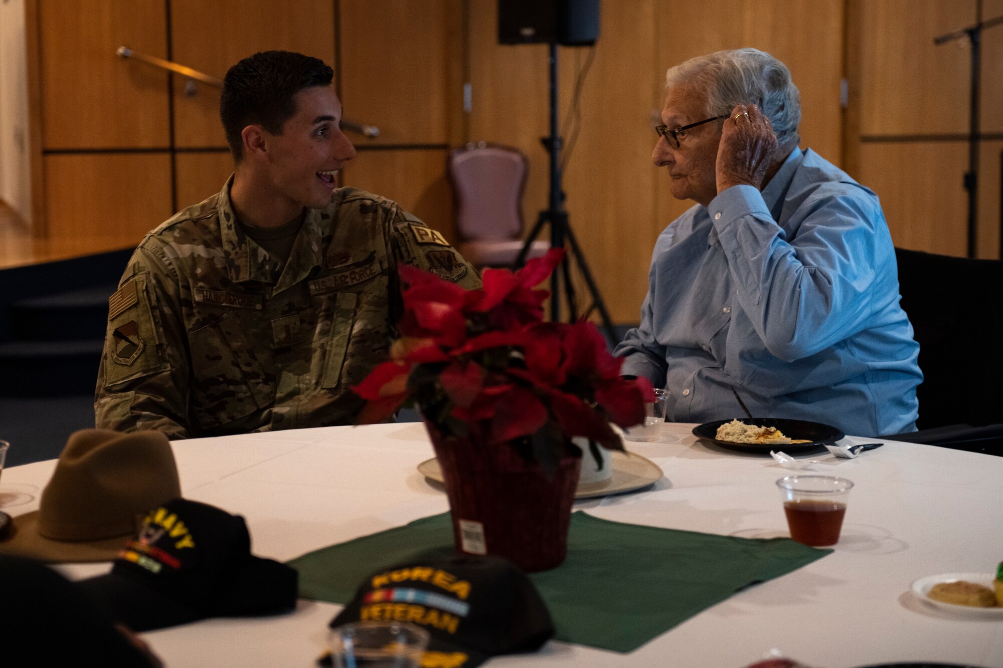 U.S. Air Force 2nd Lt. Joseph Harclerode, 325th Fighter Wing public affairs officer, talks with a senior citizen veteran at Tyndall Air Force Base, Florida, Dec. 9, 2022.