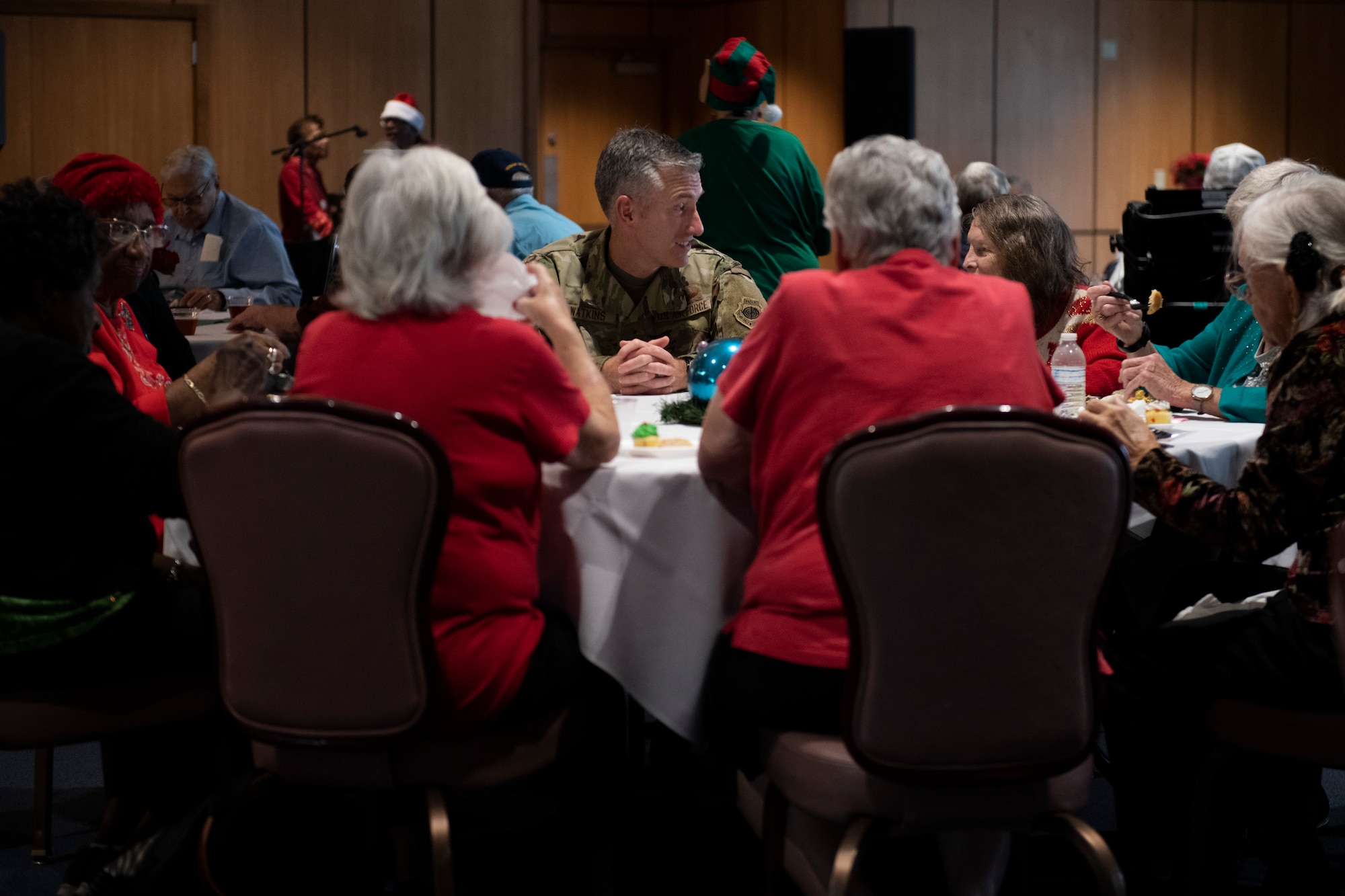 U.S. Air Force Col. George Watkins, 325th Fighter Wing commander, center, talks to senior citizen veterans at Tyndall Air Force Base, Florida, Dec. 9, 2022.