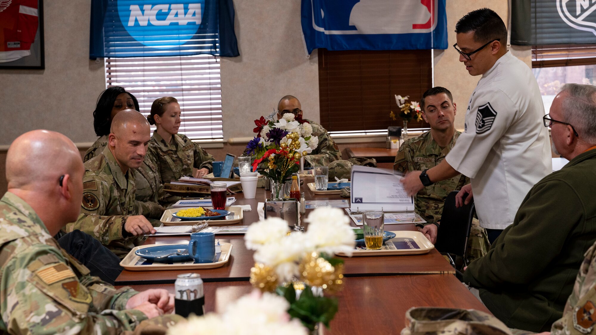U.S. Air Force Master Sgt. David Peria, 49th Force Support Squadron Shifting Sands Dining Facility superintendent, center right, explains the Food 2.0 system to U.S. Air Force Chief Master Sgt. Ryan Taylor, Air Education and Training Command first sergeant, center left, at Holloman Air Force Base, New Mexico, Dec 9, 2022. Taylor learned how Holloman is preparing their Airmen and first sergeants for the upcoming transition to Food 2.0. (U.S. Air Force photo by Airman 1st Class Nicholas Paczkowski)