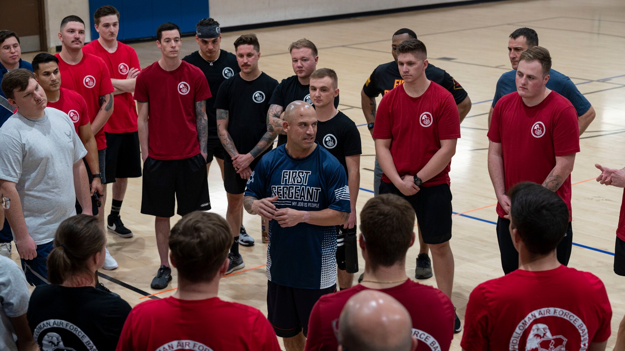 U.S. Air Force Chief Master Sgt. Ryan Taylor, Air Education and Training Command first sergeant, speaks to Airman Leadership School students at Holloman Air Force Base, New Mexico, Dec. 9, 2022. Taylor participated in the ALS versus first sergeants and chiefs volleyball game, which teaches students to work as a team and use communication skills. (U.S. Air Force photo by Airman 1st Class Nicholas Paczkowski)