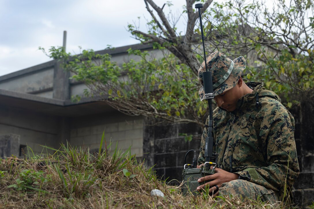 U.S. Marine Corps Lance Cpl. Nathaniel Soto, a fire support marine with 3d Battalion, 4th Marines, sets up communications equipment during Stand-in Force Exercise on Okinawa, Japan, Dec 7, 2022. SiF-EX is a Division-level exercise involving all elements of the Marine Air-Ground Task Force focused on strengthening multi-domain awareness, maneuver, and fires across a distributed maritime environment. This exercise serves as a rehearsal for rapidly projecting combat power in defense of allies and partners in the region. Soto is a native of Houston, TX. (U.S. Marine Corps photo by Cpl. Davin Tenbusch)