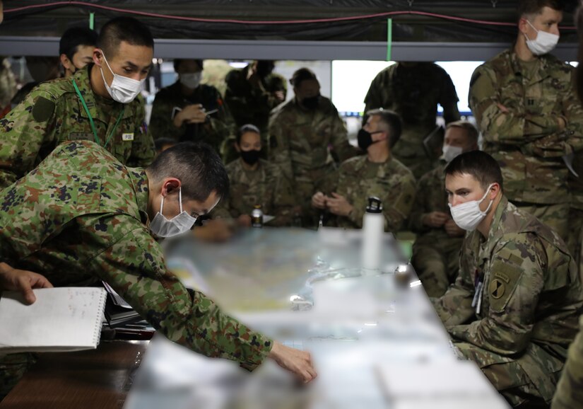 U.S. Army Soldiers and Japan Ground Self Defense Force members participate in a morning briefing during Yama Sakura 83 at Camp Kengun, Japan, Dec. 7, 2022. This exercise strengthens bilateral partnerships that contribute to the defense of Japan and regional stability in the Indo-Pacific. (Proprietary information redacted) (U.S. Army National Guard Photo by Sgt. 1st Class Tom Foster)