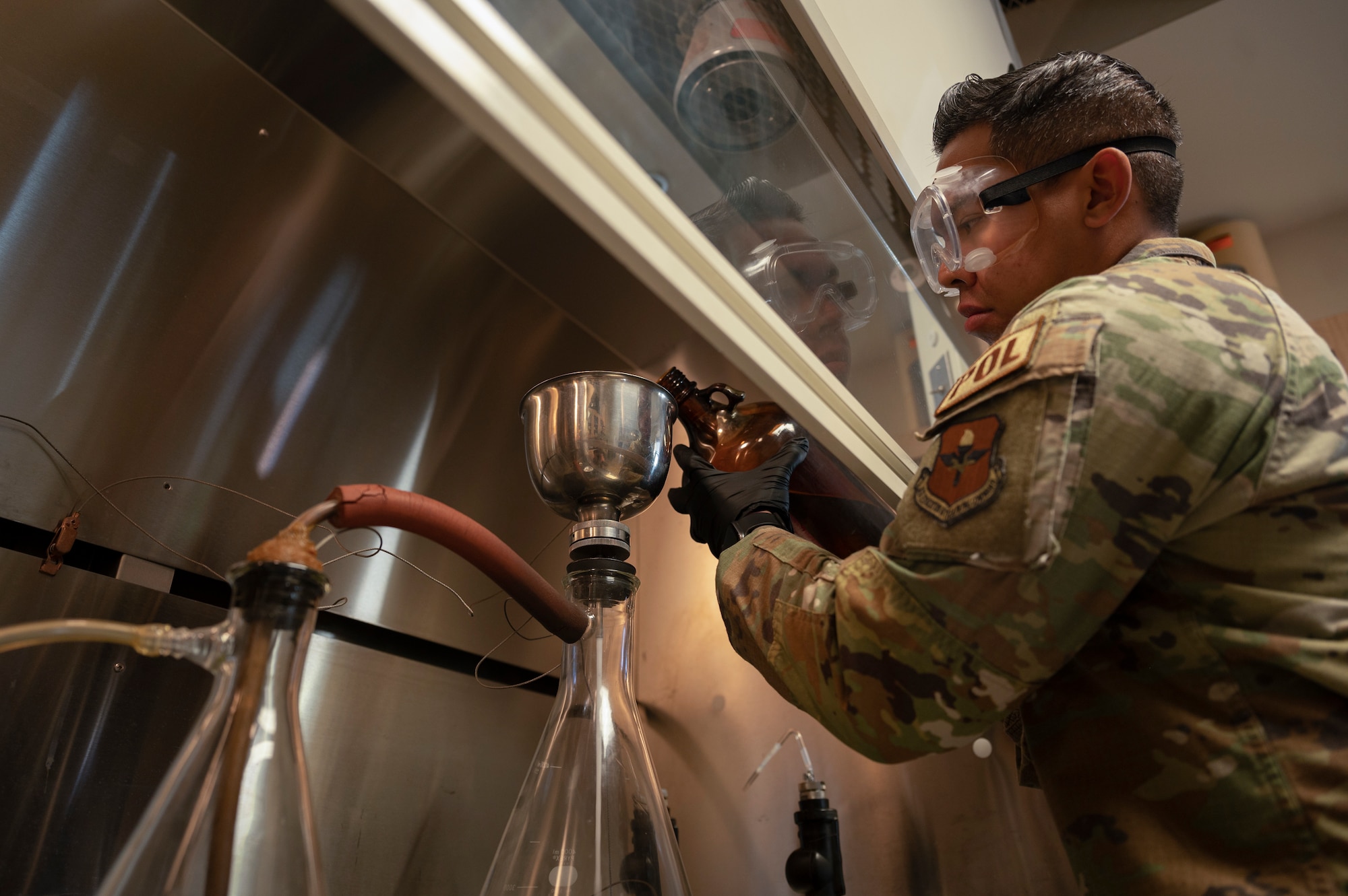 U.S. Air Force Staff Sgt. Austin Taitingfong, 49th Logistic Readiness Squadron fuels laboratory noncommissioned officer in charge, filters a fuel sample at Holloman Air Force Base, New Mexico, Dec. 12, 2022. The 49th LRS fuel flight’s priority is to ensure that clean, dry, serviceable fuel products are provided to further the 49th Wing’s mission in the air and on the ground. (U.S. Air Force photo by Airman 1st Class Isaiah Pedrazzini)