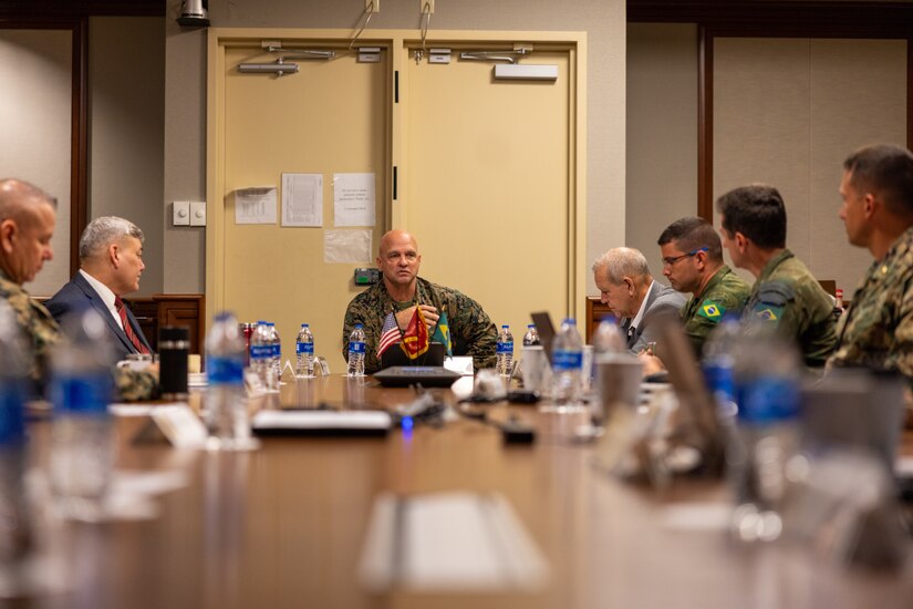 U.S. and Brazilian forces sit around a table.