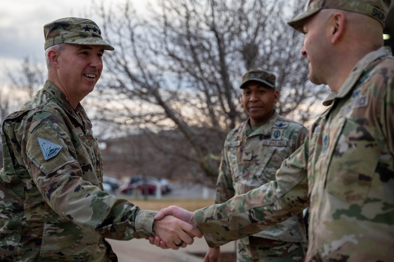 Lt. Gen. Stephen Whiting, commander of Space Operations Command, left, is greeted by Chief Master Sgt. Charles Shurchay, Senior Enlisted Leader of Space Base Delta 2, right, to begin his visit to the delta at Buckley Space Force Base, Colo., 12 Dec, 2022.