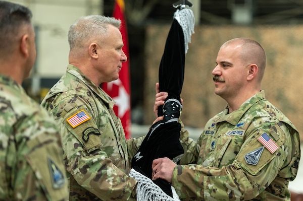 Gen. Paul LaCamera, United Nations Command / Combined Forces Command / United States Forces Korea commander, passes the U.S. Space Forces Korea guidon to U.S. Space Force Lt. Col. Joshua McCullion, USSFK inaugural commander, during the unit’s activation ceremony at Osan Air Base, Republic of Korea, Dec. 14, 2022. The newly activated USSFK will be tasked with coordinating space operations and services such as missile warning, position navigation and timing, and satellite communications within the region.