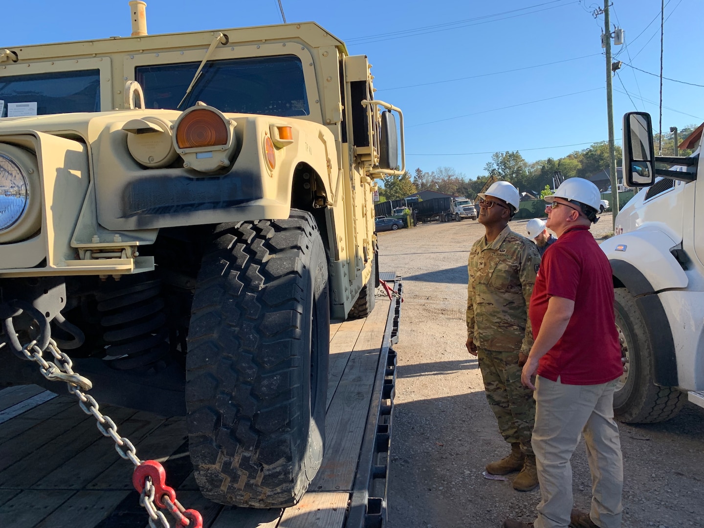 men inspect vehicle