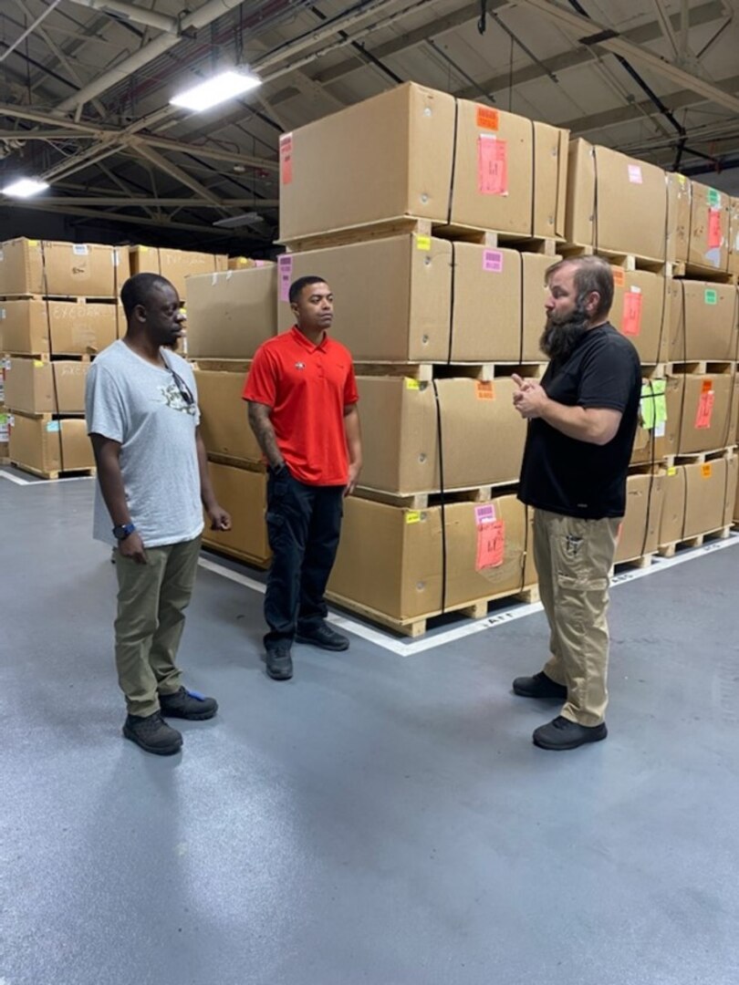 men talking in warehouse