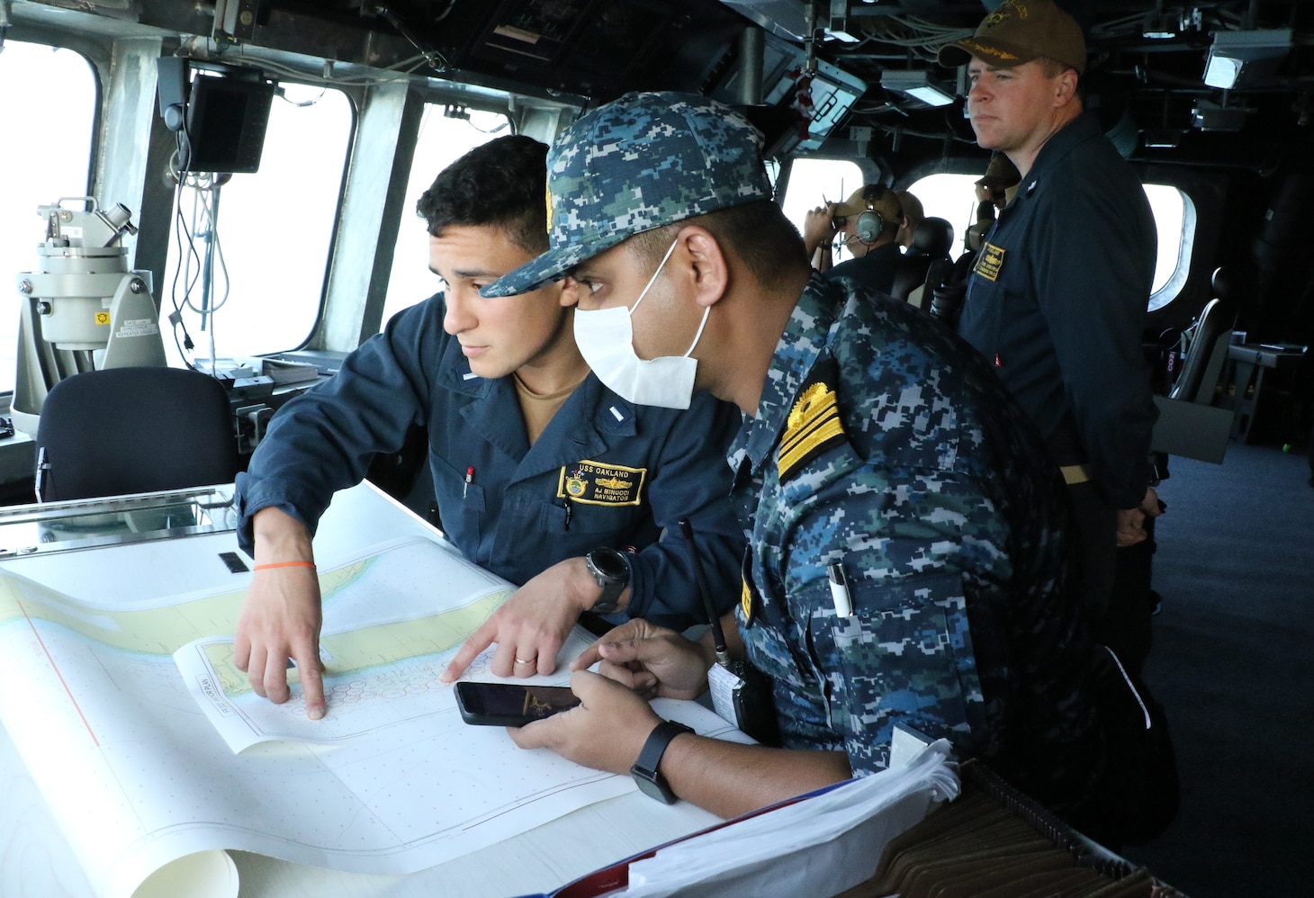 COX’S BAZAR, Bangladesh (Dec. 5, 2022) – Lt. Anthony Minucci, from Wauwatosa, Wisconsin, navigator for the Independence-variant littoral combat ship USS Oakland (LCS 24), coordinates anchoring position with a Bangladesh Navy (BN) officer prior to International Fleet Review 2022 in Cox’s Bazar, Bangladesh, Dec. 5. Oakland is participating in IFR 2022 organized by the Bangladesh Navy, which intends to promote good will, strengthen cooperation and serve as an ideal platform for world’s navies to showcase their prowess, naval diplomacy, and cooperation in a global arena. (U.S. Navy courtesy photo)