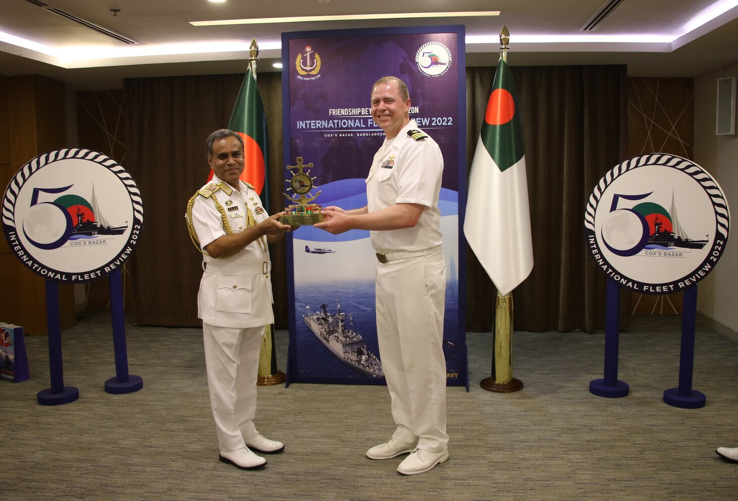 COX’S BAZAR, Bangladesh (Dec. 6, 2022) – Bangladesh Chief of Naval Staff Adm. M Shaheen Iqbal and Cmdr. Derek Jaskowiak, commanding officer of the Independence-variant littoral combat ship USS Oakland (LCS 24), exchange gifts during the International Fleet Review (IFR) 2022 reception in Cox’s Bazar, Bangladesh, Dec. 6. Oakland is participating in IFR 2022 organized by the Bangladesh Navy, which intends to promote good will, strengthen cooperation and serve as an ideal platform for world’s navies to showcase their prowess, naval diplomacy, and cooperation in a global arena. (U.S. Navy courtesy photo)