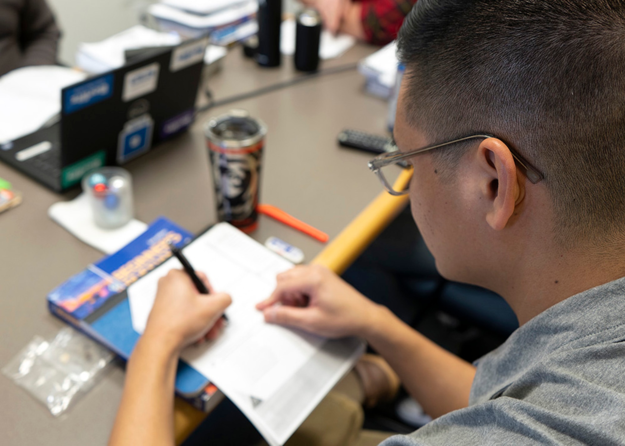 A 70th Intelligence, Surveillance and Reconnaissance Wing cryptologic language analyst writes notes during a re-language course, Dec. 5, 2022, Odenton, Maryland. The Air Force Intelligence, Surveillance and Reconnaissance Cryptologic Language Analyst Optimization Plan provides linguists an opportunity to learn multiple languages while maintaining proficiency within their primary career field language. (U.S. Air Force photo by Staff Sgt. Kevin Iinuma)