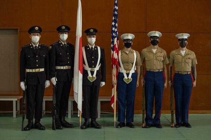 The U.S. Marine Corps III Marine Expeditionary Force Support Battalion color guard and Japan Ground Self-Defense Force color guard members participate in the 2022 Reunion of Honor on Iwo To, Japan, Dec. 10, 2022. The Reunion of Honor is an annual ceremony that commemorates the sacrifices made by both Japanese and American service members who fought during World War II on Iwo To.