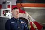 Coast Guard Petty Officer 2nd Class Jake Flores, maritime enforcement specialist at Maritime Safety & Security Team Houston and 2022 USO Service Member of the Year honoree, beams during a ceremony in Houston, Texas, Dec. 1, 2022. Flores’s command nominated him for the award for jumping into the Rio Grande to save a drowning baby during a patrol on June 2, 2022. (U.S. Coast Guard photo by Petty Officer 1st Class Corinne Zilnicki)