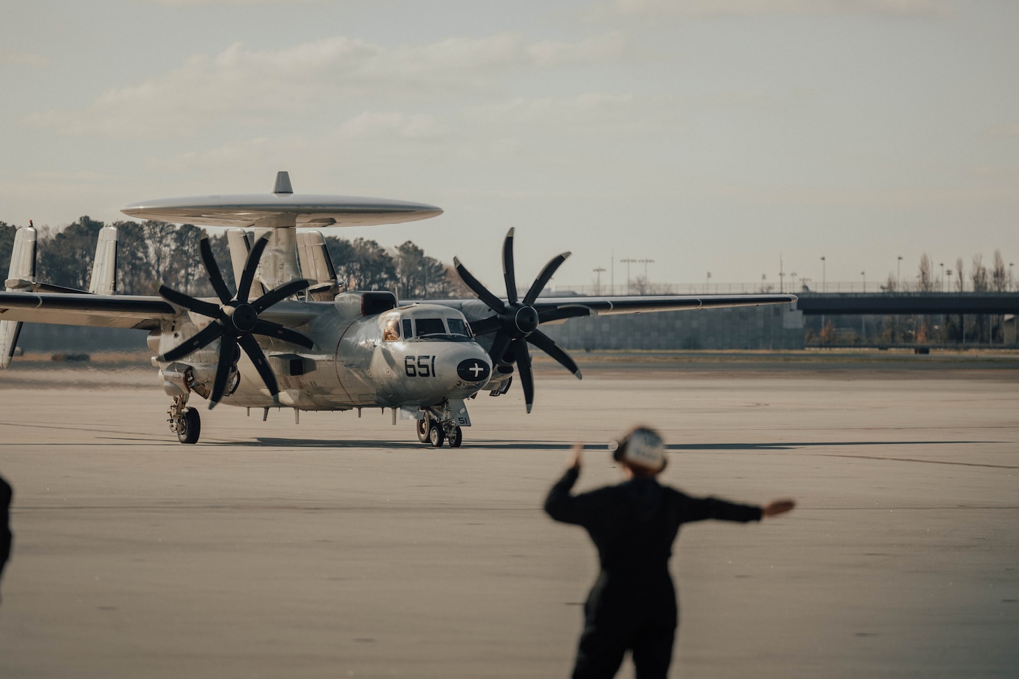 Sailor signaling an airplane on the runway