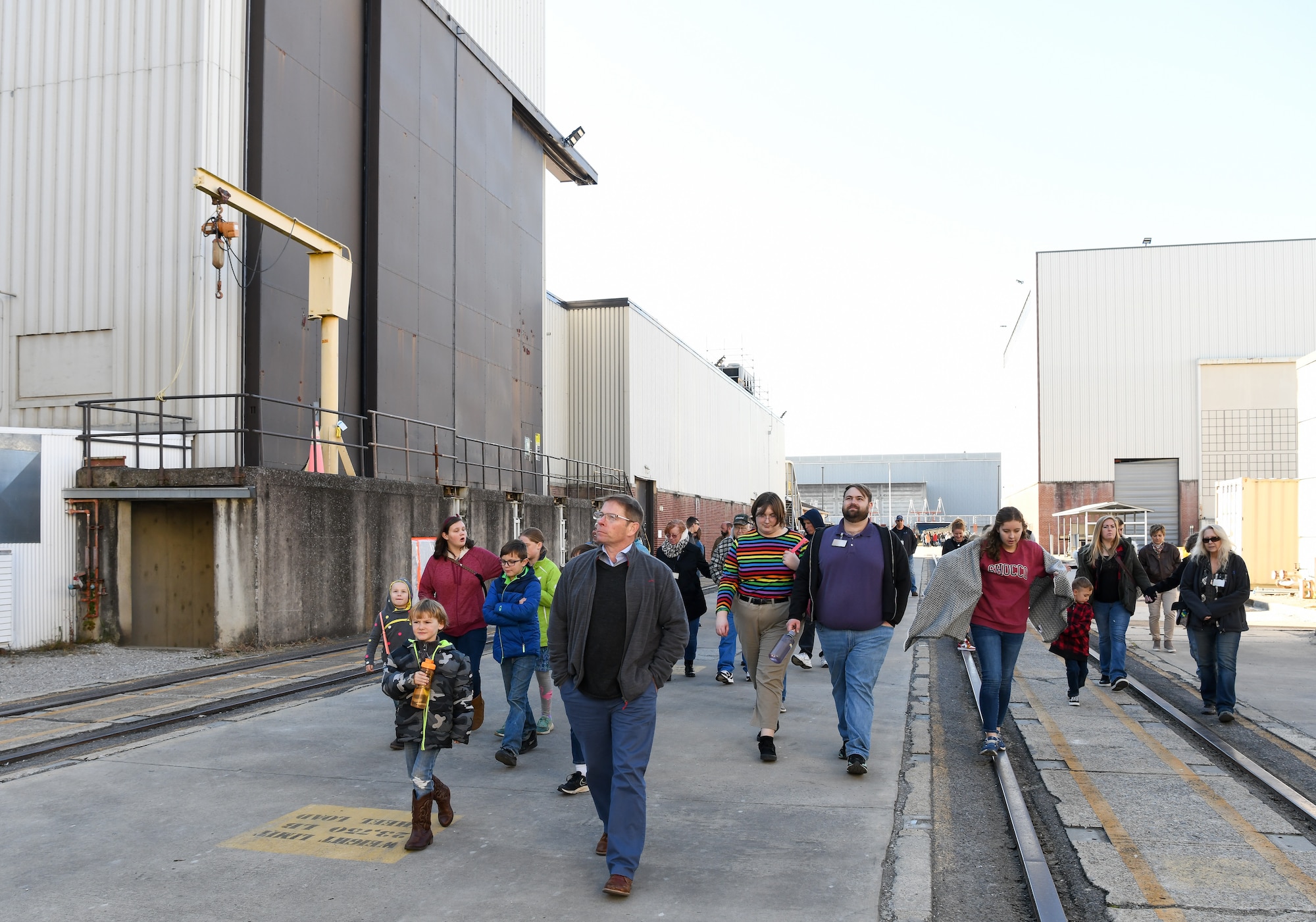 Group of people walking outside in an industrial area