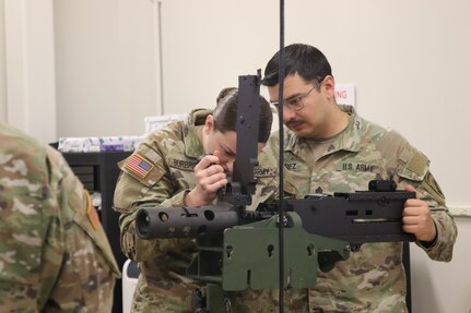 Sgt. Mariano Alvarez assist Spc. Emma Burbridge with disassembling the M2 Machine Gun.
During the 7-day unit armorer course at RTSM-Devens, 19 students learned how to disassemble reassemble and perform a functions check on 7 different weapons systems.