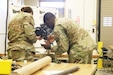 Sgt. 1st Class Jerry Fumba assist Spc. Emma Burbridge with reassembling the Mark 19.
During the 7-day unit armorer course at RTSM-Devens, 19 students learned how to disassemble reassemble and perform a functions check on 7 different weapons systems.