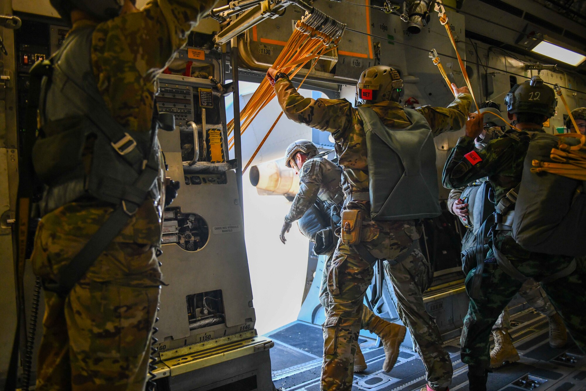 A U.S. Army soldier jumps out of a C-17 Globemaster III from the 58th Airlift Squadron based out of Altus Air Force Base (AAFB), Oklahoma, over the Sicily Drop Zone near Fayetteville, North Carolina, Dec. 9, 2022. Over the two day operation, the AAFB aircrew dropped more than 800 jumpers. (U.S. Air Force photo by Airman 1st Class Kari Degraffenreed)
