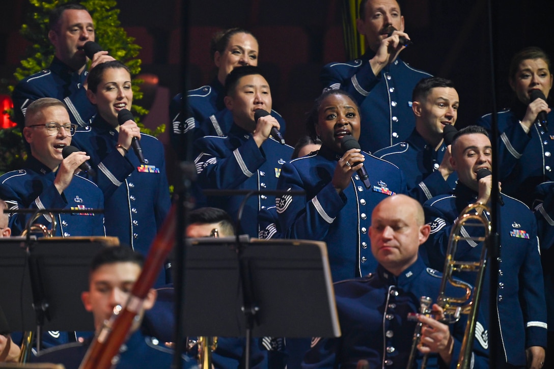 Members of a band sing or play instruments during a concert.