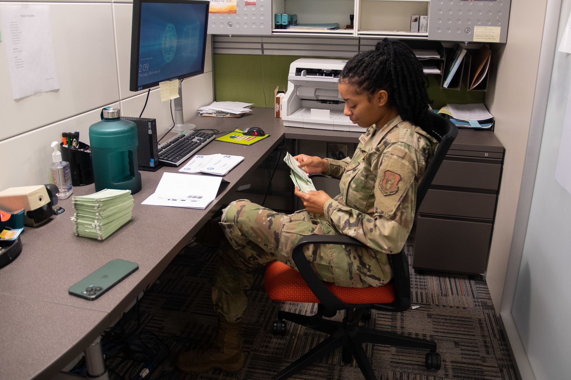 An Airman sifts through medical records.